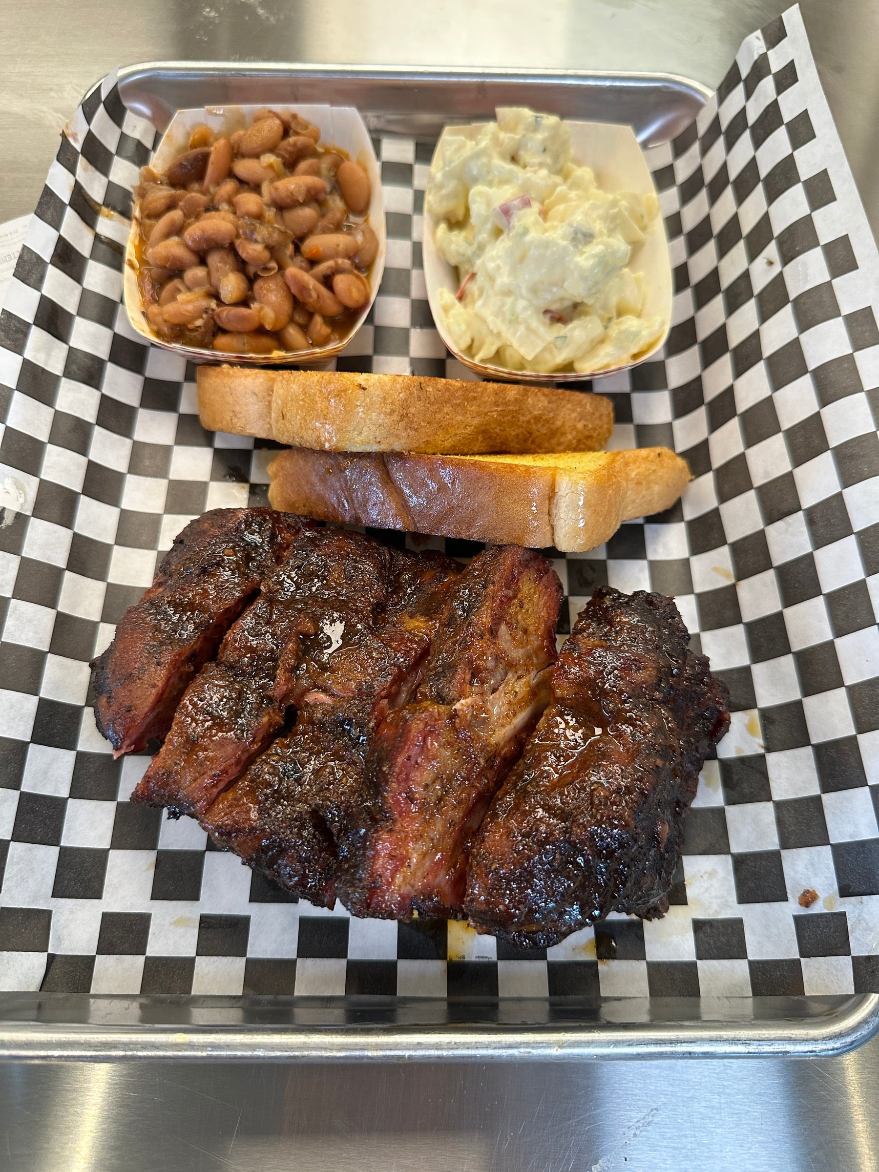 Smoked ribs served with barbecue sides